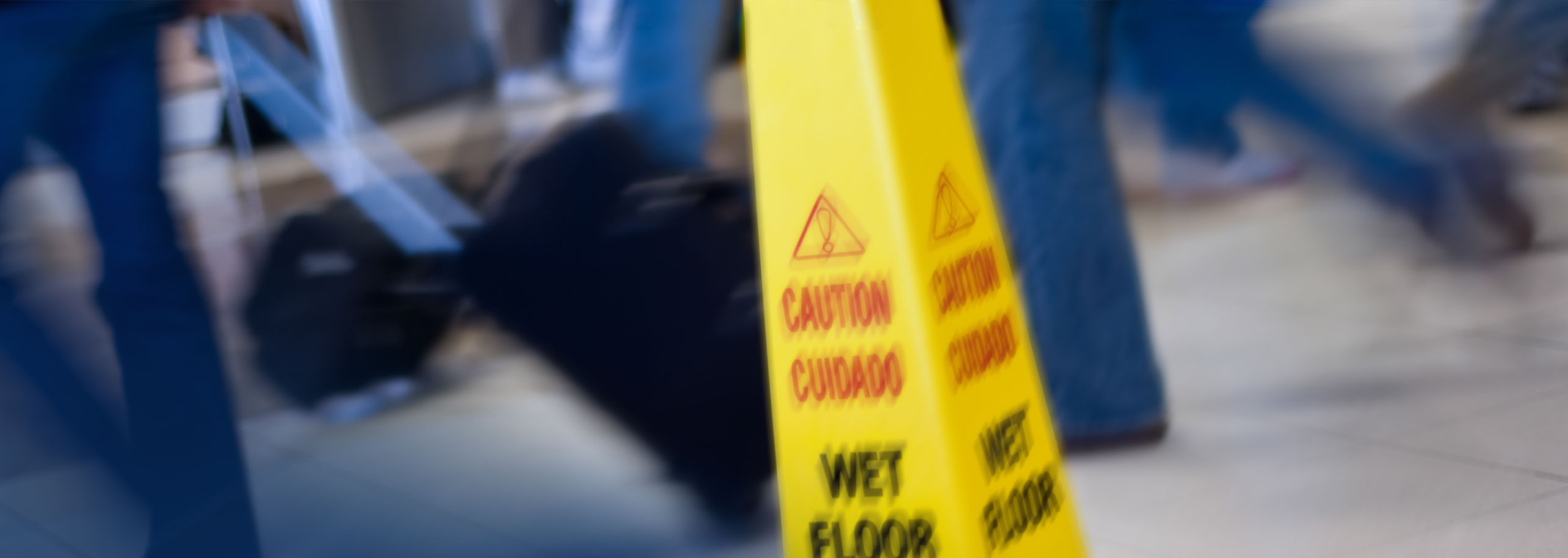 Wet floor sign with people walking by